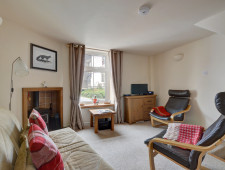 Comfortable seating and a woodburner in the sitting room Comfortable seating and a woodburner in the sitting room