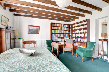 The dining room here with unique feature wall, with many books and games
