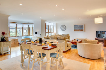 Bright and modern the open plan living area with dining table