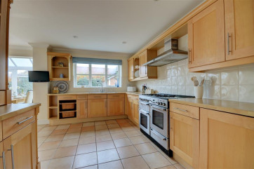 View of the kitchen with a good range of cupboards.