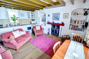 Characterful and cosy Lounge/Kitchen/Diner with wood-burning stove.