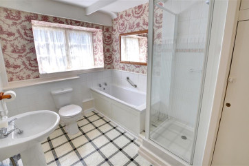 The spacious bathroom has a separate shower cubicle