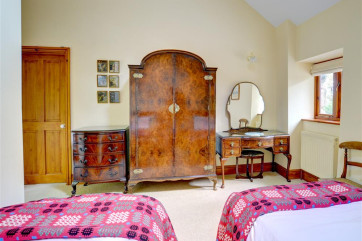 The twin bedroom also has impressive antique bedroom furniture