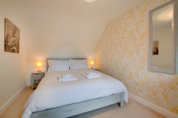 Beautifully decorated with sunny soft furnishings in the king size bedroom