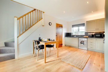 Bright and modern, the kitchen is well equipped with stairs to the first floor