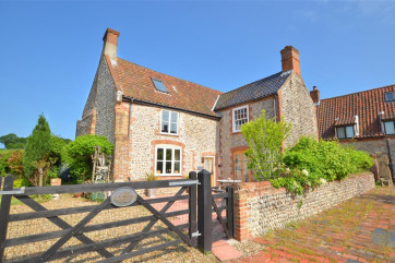 The traditional brick and flint farmhouse, built originally in the 1700s is full of character, has quirky features and a magnificent inglenook fireplace which is listed and described in Pevsner's Buildings of Norfolk.