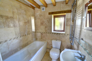 Smart contemporary bathroom with shower over bath