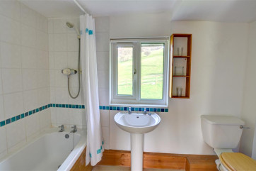 The second smaller bathroom also has a shower over the bath, and lovely views over open fields!