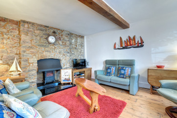 Living/Dining Room: Open plan living accommodation with dining table chairs and bench in one corner and comfortable sofas. Freeview TV, DVD & Blu-ray player. This spacious area has a cosy cottage feel with its exposed walls and nautical theme.