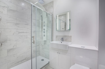 Contemporary ensuite shower room, with walk in shower, basin and wc