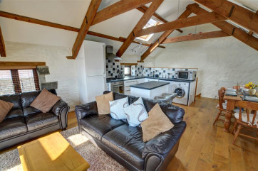 Beams, wood floor and some stone walling retain the original features and character of The Barn