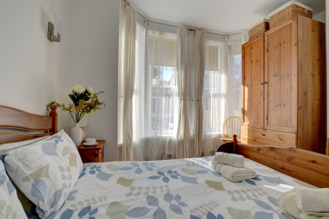 Light and bright double bedroom attractively furnished with large bay windows