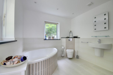 Large family bathroom complete with underfloor heating, luxurious corner bath and walk-in shower
