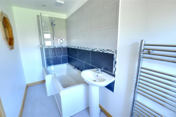 Over bath shower in this well planned en-suite