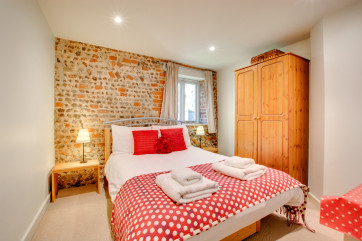 Bedroom with double bed and feature wall