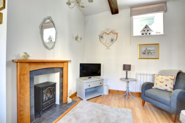 The cosy lounge has a feature fireplace.