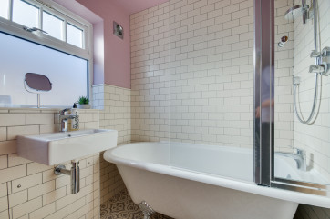 Bathroom with bath, over bath shower, washbasin and wc