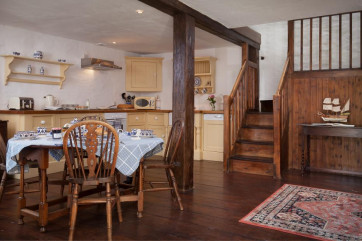 country cottage with exposed beams and open-plan kitchen dining room