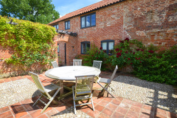 This walled patio area is a perfect spot for some relaxation .