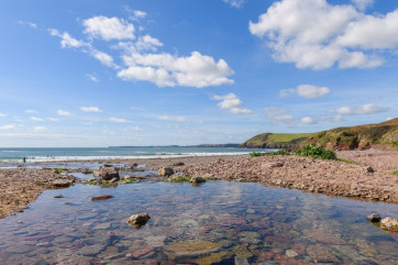 There is a sandy beach at Manorbier with rock pools to investigate