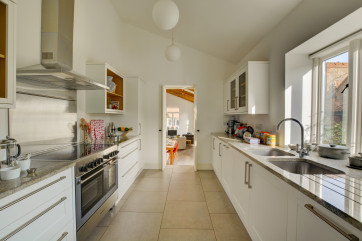 A sleek modern kitchen with clean lines and airy feel.