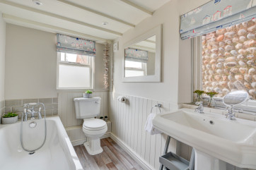 Bathroom with bath, hand held shower, washbasin and wc