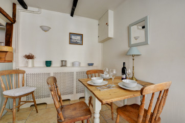 Table and chairs with window looking out to the front of the property.