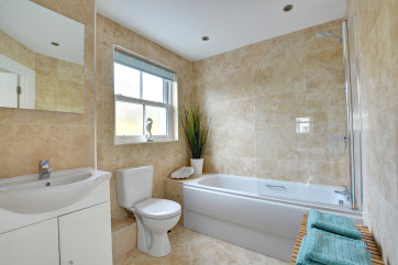 Bath with shower over, toilet and wash basin
