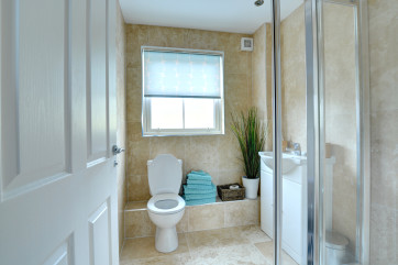 En-suite shower room with toilet and wash basin