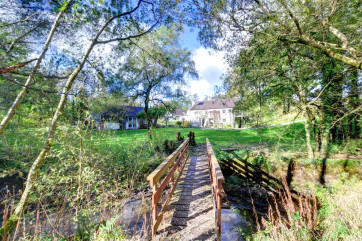 The cottages stands in a peaceful rural location with a river flowing through the grounds