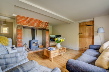 Cosy sitting room with wood burner and comfortable seating