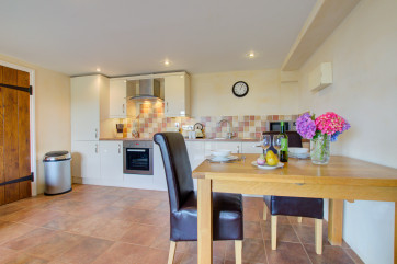 The kitchen is very well equipped and has a dining table for two