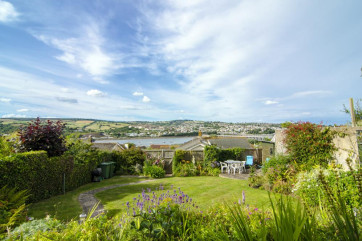 Beautifully kept garden bathed in sunshine with glorious river views