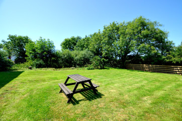 Picnic table in the large enclosed garden to the rear of the property