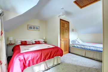 Family bedroom, includes a double bed and single bed, wardrobes and chest of drawers
