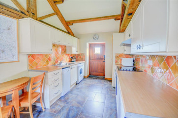 Well equipped kitchen with vaulted ceiling.
