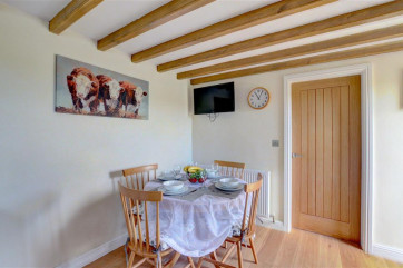 Spacious Dining Area with table and chairs.