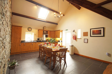 A character oak kitchen with slate floor and a farmhouse pine table