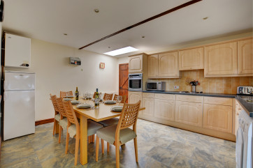 Spacious modern kitchen with most major appliances and a table and chairs to seat 8, ideal for family meals