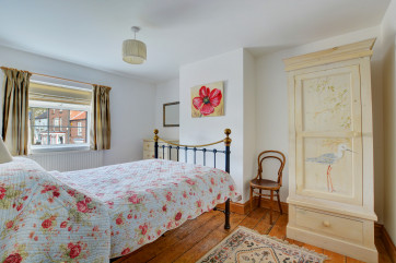 Tasetfully decorated double bedroom with handpainted furniture