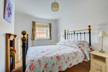 Double bedroom, tastefully furnished with a wrought iron bedstead