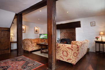 Spacious living area with wood burner at Hutchinghayes Barn, Combe Raleigh