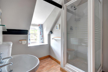 Bright and airy en-suite shower room with views over the bay.