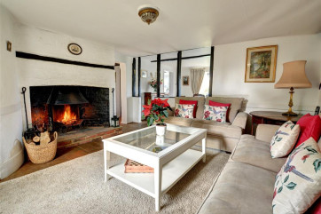 So stylish and welcoming with comfortable sofas around a wood burning stove