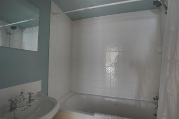 Nice bathroom with shower over the bath.