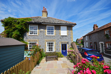 An attractive brick and flint semi detached cottage.