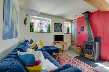 Lounge with comfortable seating, woodburner & TV