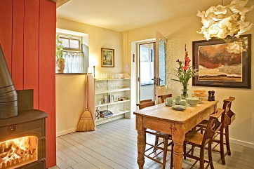 Dining area open plan to the sofa and woodburner