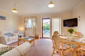 Bright sitting room with dining area which leads out to the courtyard