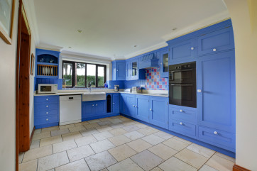 Large modern well equipped kitchen overlooking the rear garden